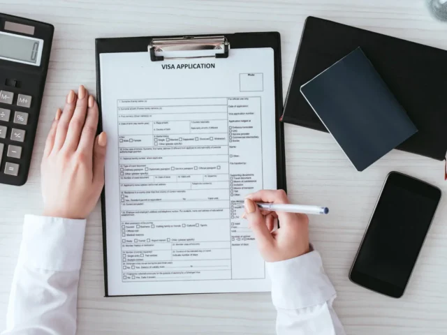 top-view-of-woman-holding-pen-near-document-with-v-2024-11-01-01-43-35-utc